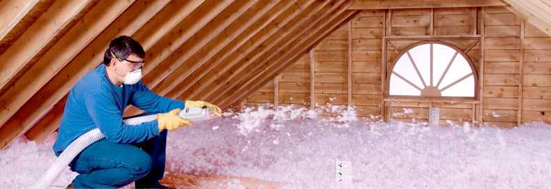 Roofing_Insulation_790x271 worker installs attic insulation